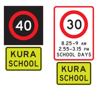 Two school speed signs, both with a speed limit at the top and a yellow and black sign reading kura school at the bottom. The right sign has hours listed as well as the speed limit.