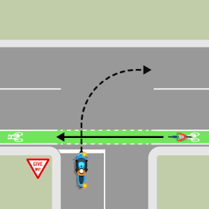 A blue motorcycle is indicating right to turn onto the continuing road from a driveway. A bicycle is approaching from the right on a footpath. The motorcycle must give way to the bicycle.