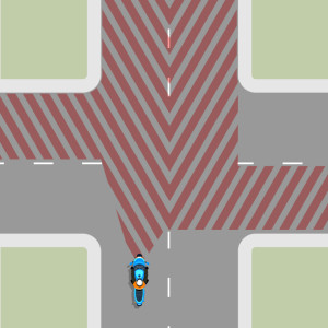 A 4 way intersection with the areas shaded that a driver should check.