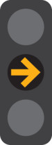 A 3 light traffic signal with the middle yellow arrow light on.