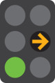 A 6 light traffic signal with the middle right yellow arrow on and the bottom green light on.