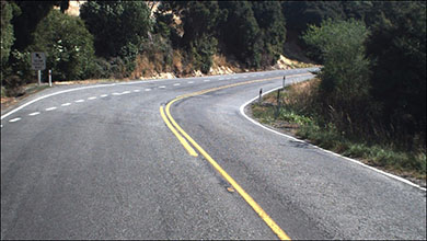 Image showing a curve state highway with markings as a sample of a slow vehicle bay
