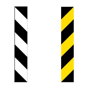 Two marker posts where the left post is a white retroreflective diagonal stripes and on the right is a yellow retroreflective diagonal stripes