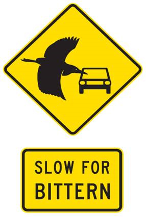 Sign with a bird flying next to a car and the words: slow for bittern