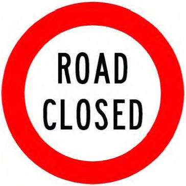 Traffic sign which says road closed with a circular red border