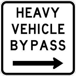 Traffic sign which says heavy vehicle bypass and a black arrow pointing to the right underneath and it has black border