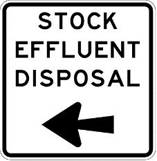 Traffic sign which says stock effluent disposal and a black arrow pointing to the left and it has black border
