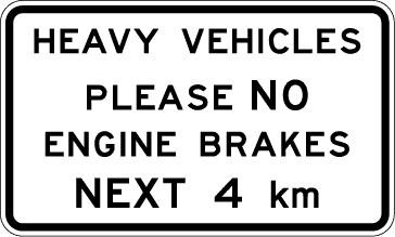 Traffic sign which says heavy vehicles please no engine brakes next 4km and it has black border