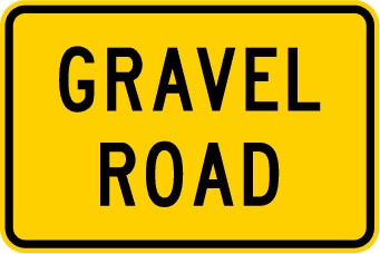 Traffic sign which says gravel road on rectangular yellow background