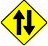 Traffic sign which displays two arrow pointing at different directions vertically
