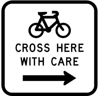 Cycle sign with a bicycle icon, words saying cross here with care in the middle, and an arrow pointing to the right underneath
