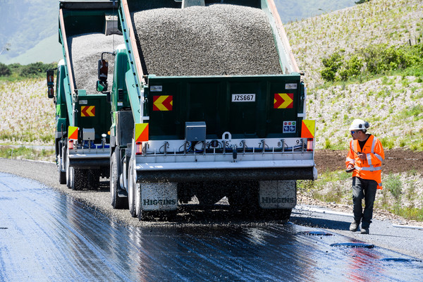 concrete trucks pour asphalt on road