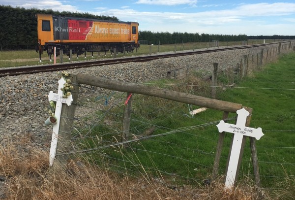 Rakaia Always Expect Trains billboard with white crosses foreground 6 April 2018