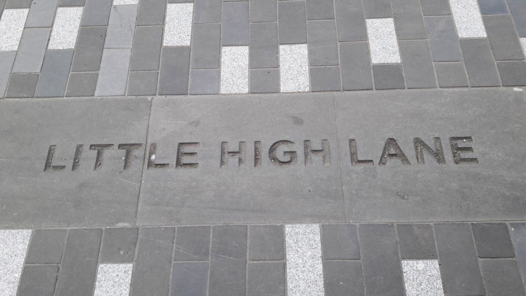 Street pavers with Little High Lane engraved into it.