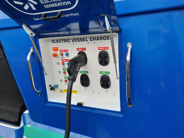 An electric ferry being charged with a CCS2 port.