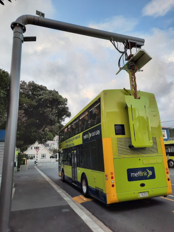 A pantograph connected to a bus at a bus stop