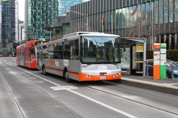 bus and tram using the same track and road at a bus stop