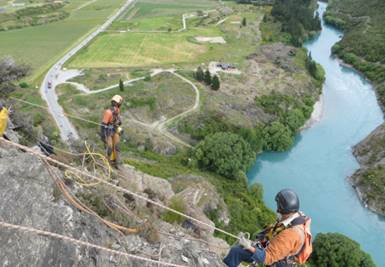 Abseilers on the Nevis Bluff, above the Kawarau River, preparing for rock blasting in past spring seasons