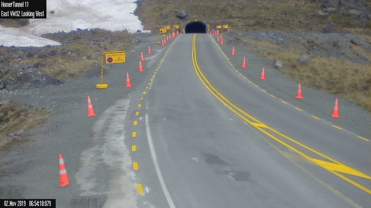 Entrance to the Homer tunnel with traffic cones down each side