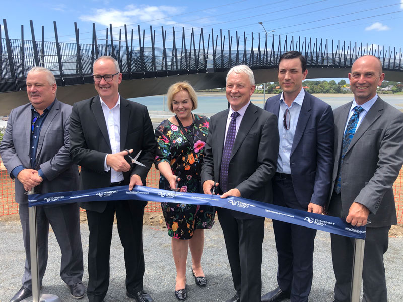 Minister of Transport Phil Twyford leads the ribbon- cutting to open new traffic lanes on the Southern Motorway. The Pescara Point pedestrian bridge in the background will open next year.