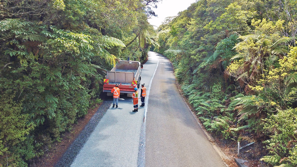 A road re-sealing crew at work in the Waipoua Forest on SH12 