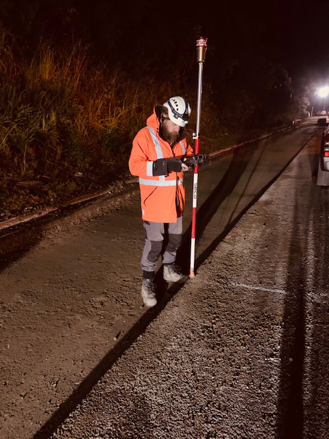 With the trench filled in, a surveyor records the exact location of the ducting for future reference if road maintenance or other work is required.