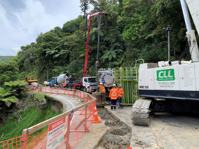 Concrete is poured into the last supporting pile needed to open SH1 through the Mangamuka Gorge before Christmas. 