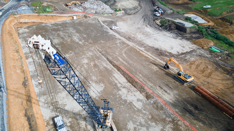 Aerial view of bridge construction works with crane machine in the background