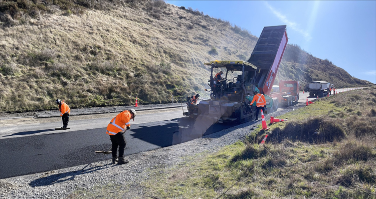 contractors pouring bitumen on the road