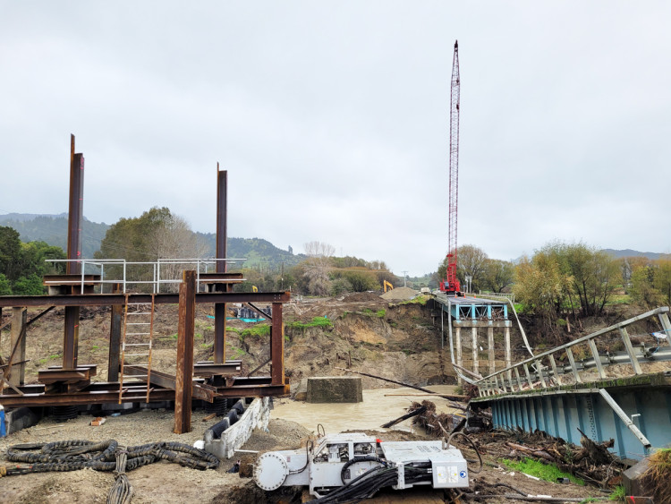 Construction site showing bridge foundation and the orange crane