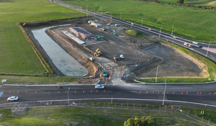 An aerial view of a road construction site with heavy machinery.