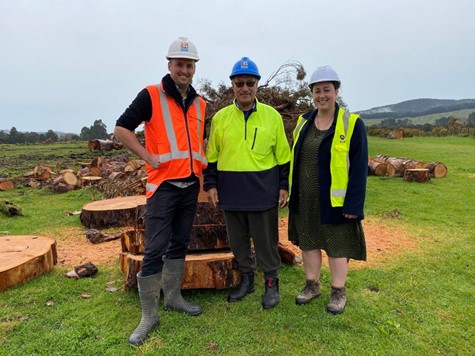 Rick Gardner (Fulton Hogan), Kuki Green (Ngāti Pāhauwera) and Kathryn Gale (Ngāti Pāhauwera) at the blessing on Monday 13 September in front of some of the firewood that will be delivered to the local community, where it will help keep homes warm next win