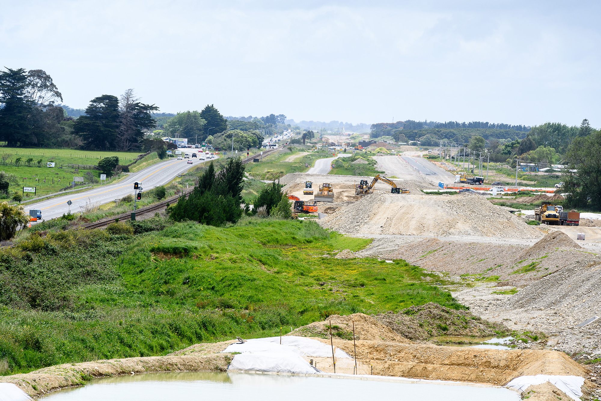 View of construction site looking south with the existing State Highway 1 travelling to the left of the construction site.