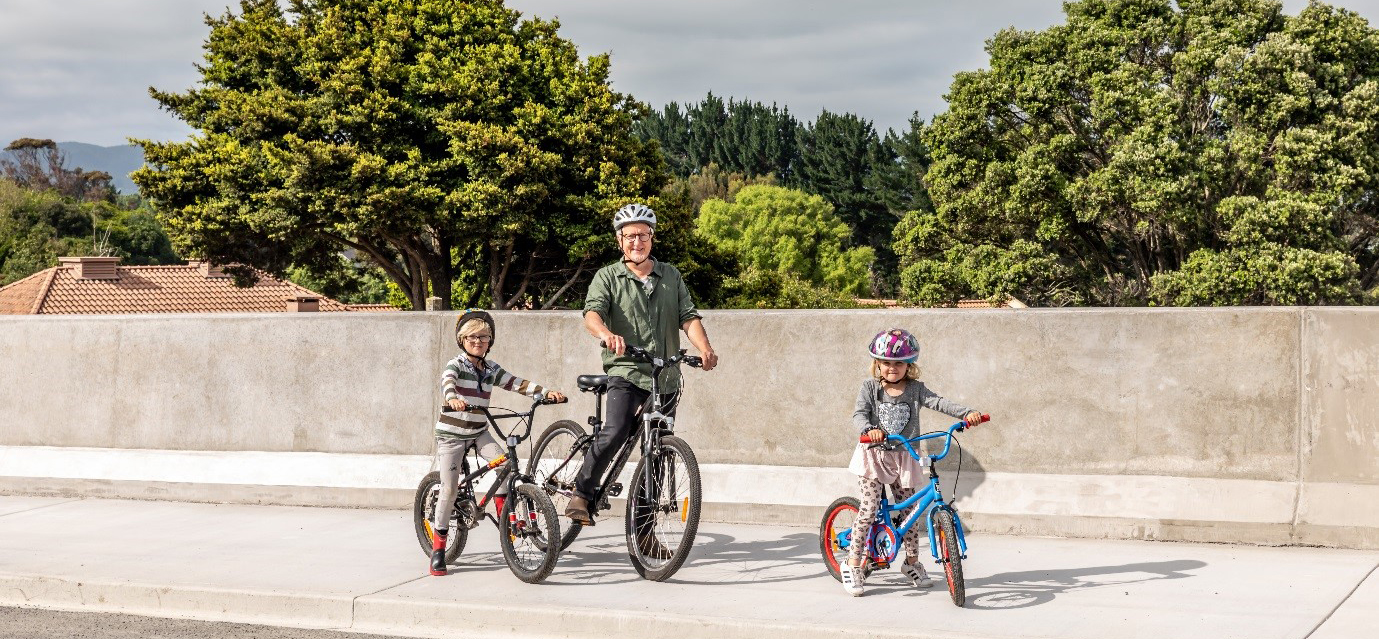 Man and two children riding their bikes on the new shared pathway.