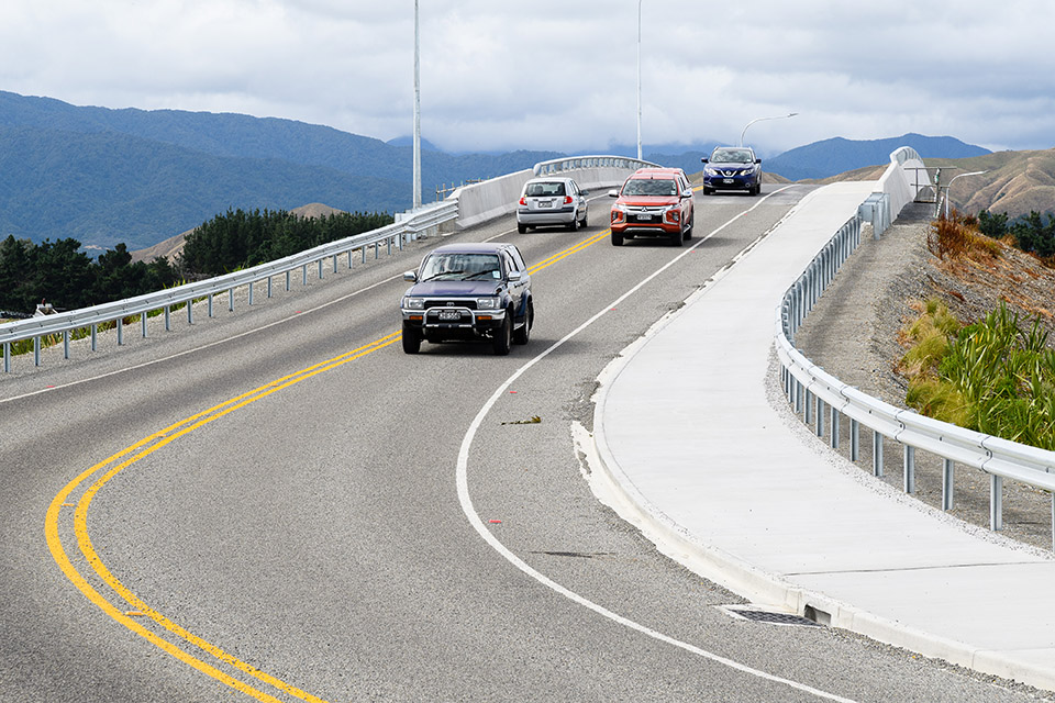 Four vehicles driving over bridge at Te Horo.
