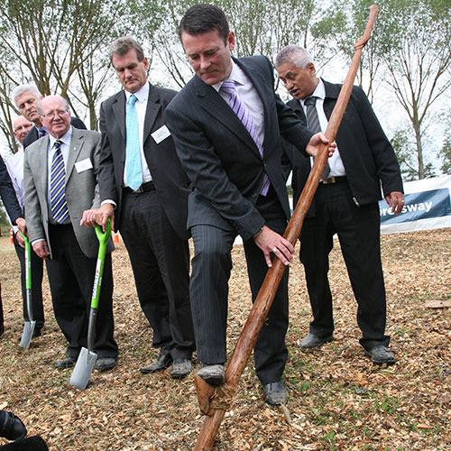 Turning the first sod. Associate Minister of Transport Michael Woodhouse is using a traditional Ko.