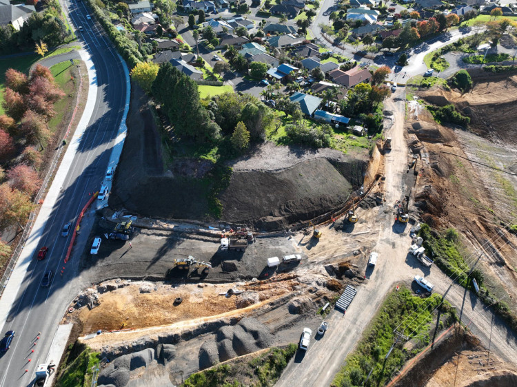 An aerial view of a road construction site with heavy machinery.