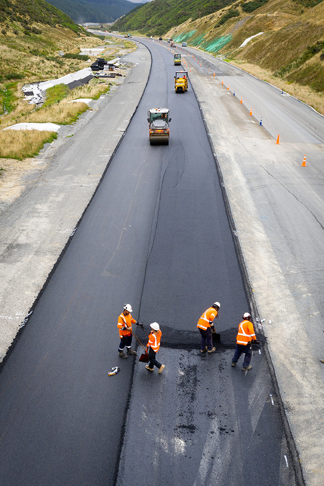 Crew laying structural asphalt