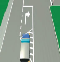 A heavy vehicle is approaching a right-turn bay which has white diagonal lines and a right-turn arrow marked on the road.
