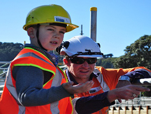 Engineer Russell Scoones pointing out features of the project site to young Mt Cook School enthusiast Dov Silberstein.