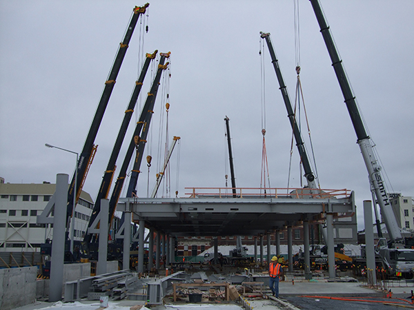 The 50 tonne roof of the new bus exchange being lifted into place.