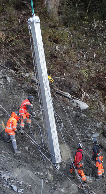 A post is being erected for the second rockfall barrier fence at Diana Falls.