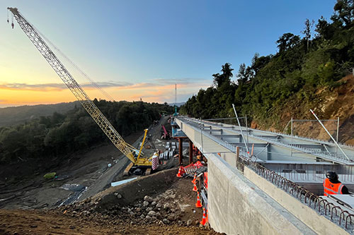 construction of the Taparahi SH25A bridge with sunset in the background