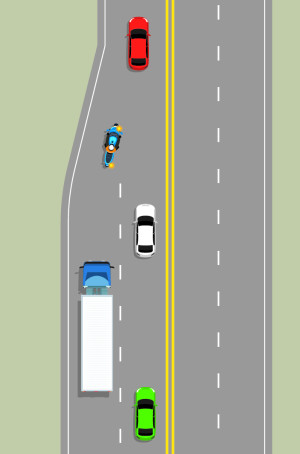 2 lanes are merging into one lane. As the vehicles merge, each takes a turn entering the single lane.