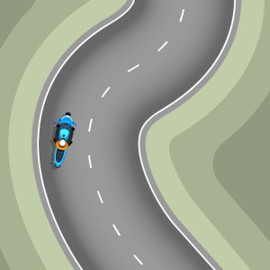 A blue motorcycle on the curve of a road. It is positioned to the left of the road.