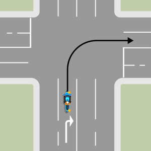 The blue motorcycle is in the right-hand turn lane. They must stay in the right-hand lane through the intersection.
