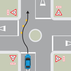 A blue car is approaching a single-laned roundabout with four exits, each with give way signs. A black arrow shows the blue car does not indicate until it is past the exit before the exit it is taking, then it signals left. The blue car stays in the same 
