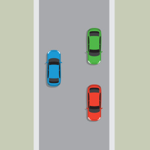 An unlaned road with a blue car driving left and passing a red car and a green car going in the other direction