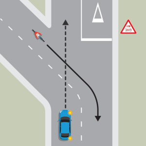 A blue car is approaching a Y intersection. The centre line curves left but the blue car is travelling straight through to the road on the right. A cyclist is travelling in the opposite direction. from the road on the right. The blue car must 