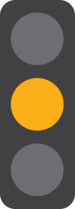 A 3 light traffic signal with the middle yellow light on.